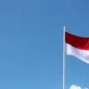 Indonesian's flag through the blue sky