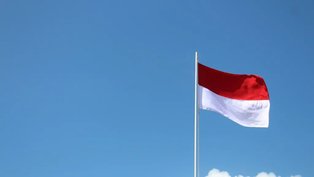 Indonesian's flag through the blue sky