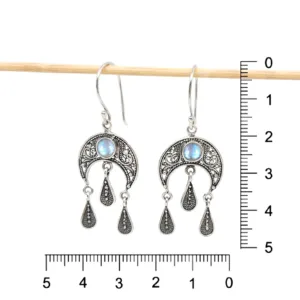 Close-up of elegant boho crescent moon earrings in sterling silver