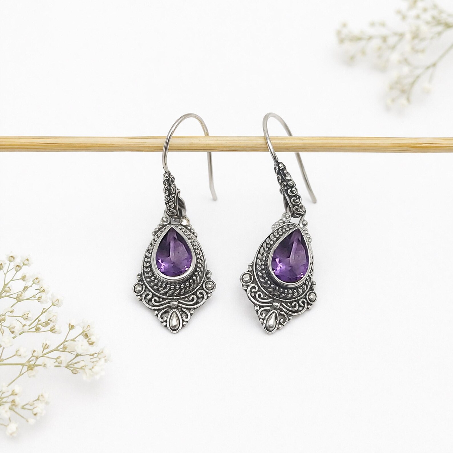 Sterling Silver Dangle Earrings Close-up Feminine sterling silver drop earrings with teardrop shape