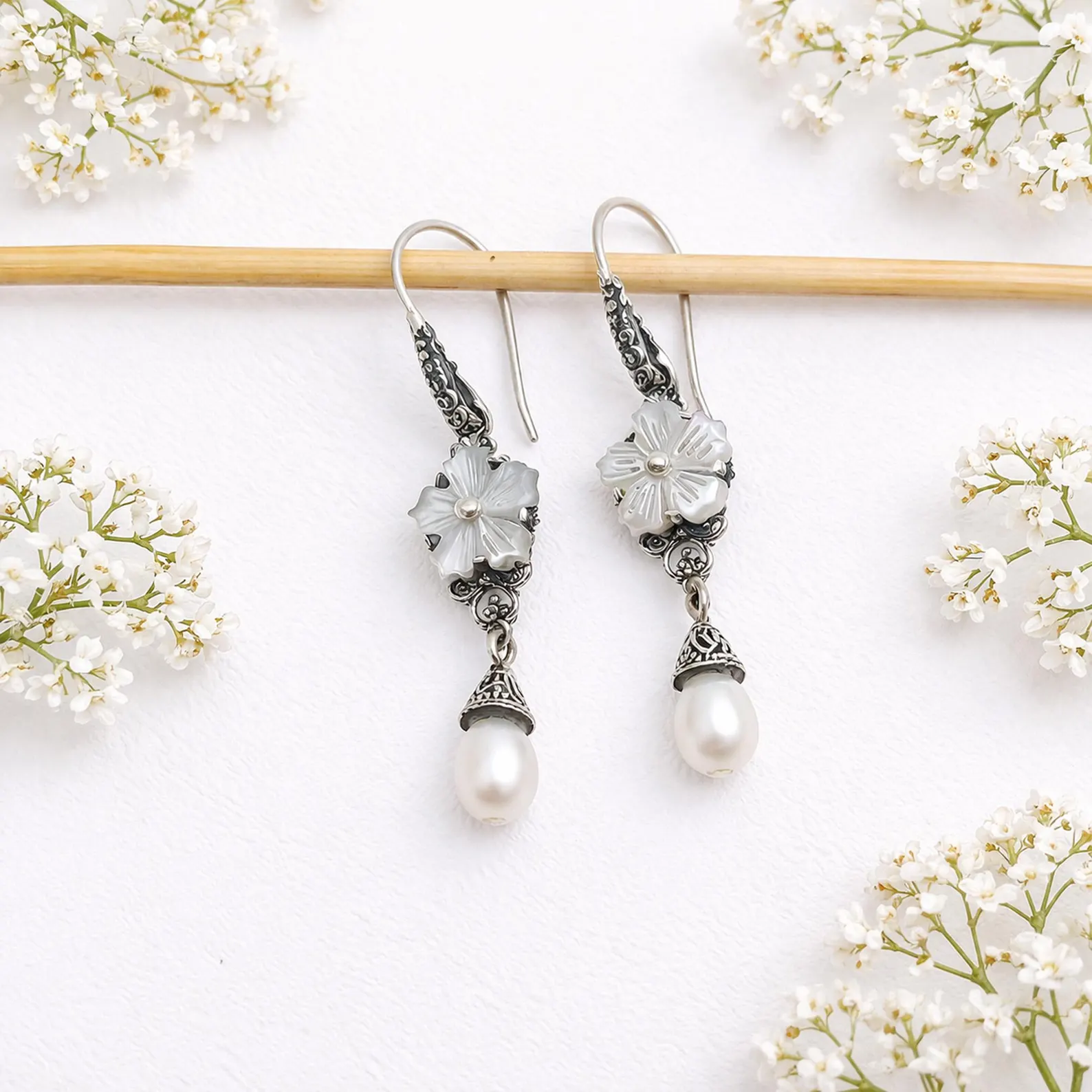 Elegant Pearl Drop Earrings on Model Close-up of boho silver flower earrings with natural pearl