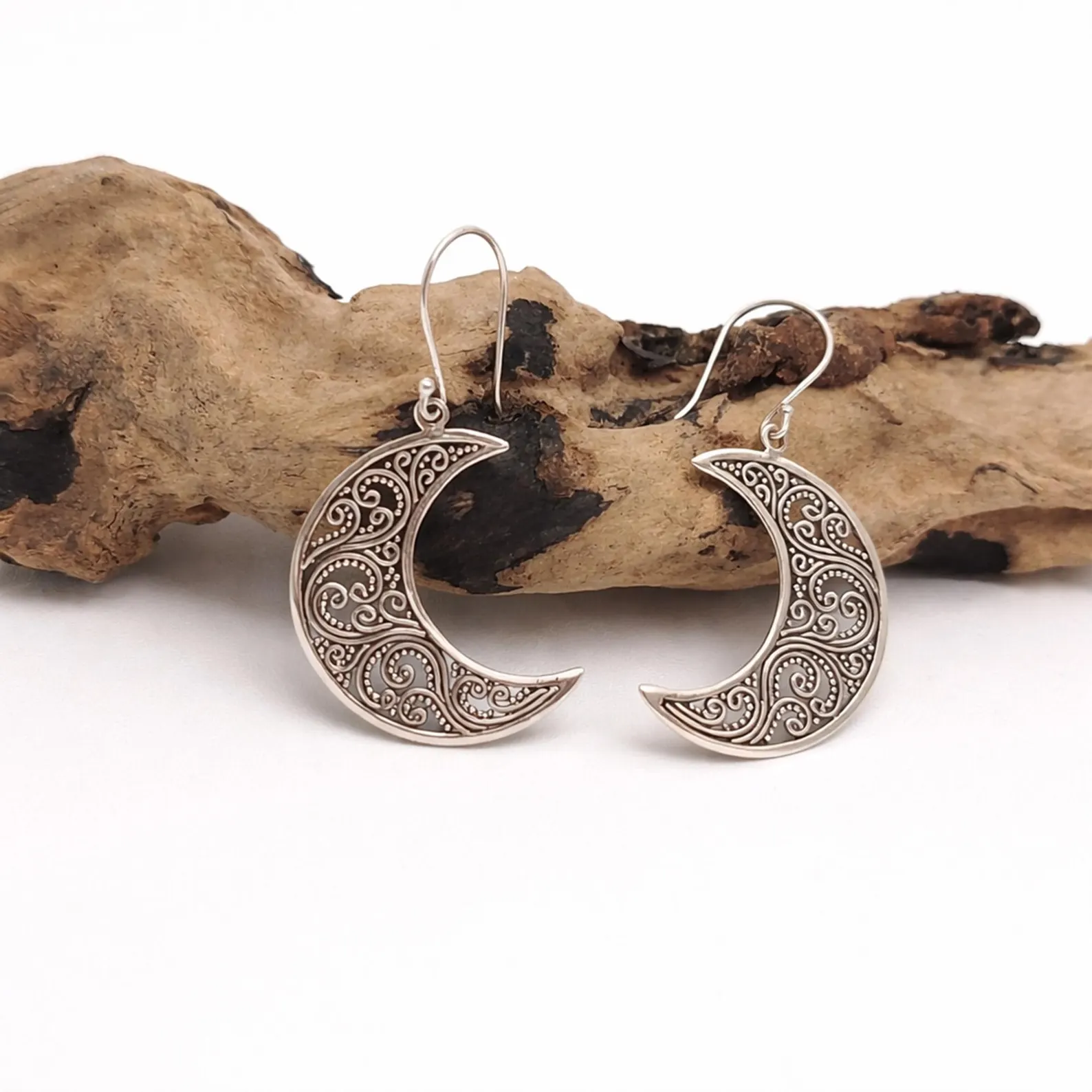 Close-up of Filigree Moon Earrings Detail Bohemian dangle earrings with crescent moon design