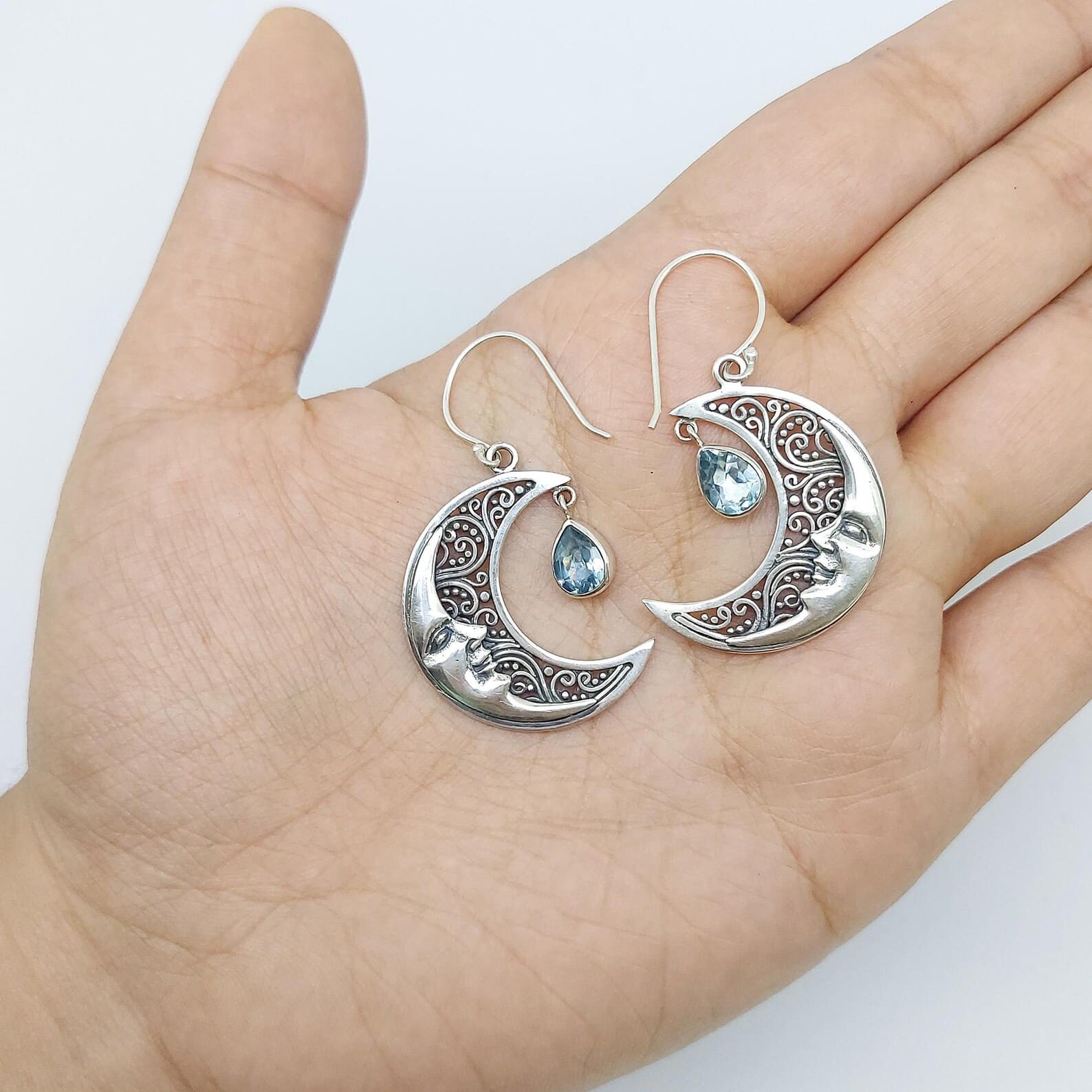 Artisan Silver Moon Earrings on Model Handmade sterling silver moon face earrings inspired by celestial design