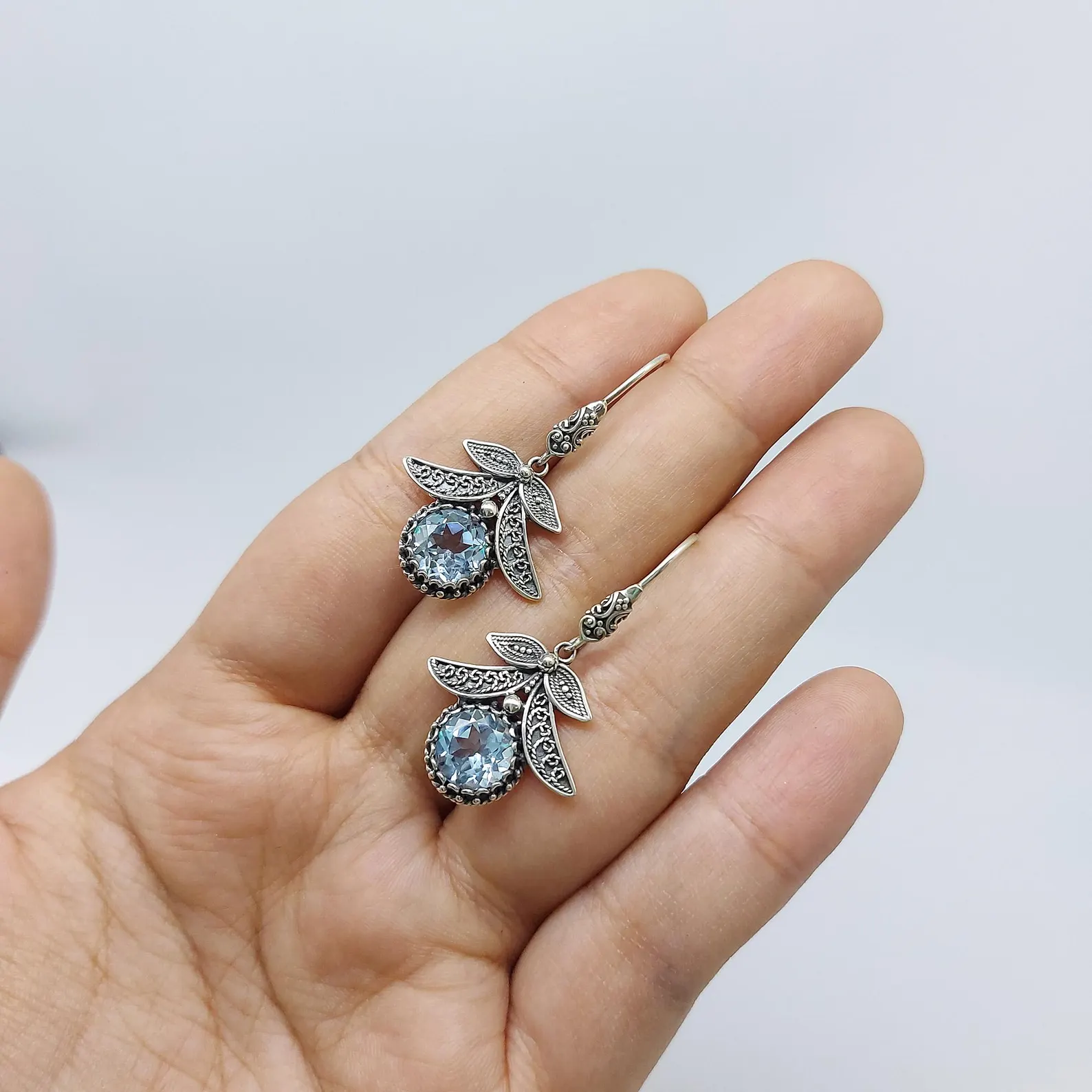 Handmade Leaf Earrings on Model Handmade sterling silver botanical leaf earrings vintage style
