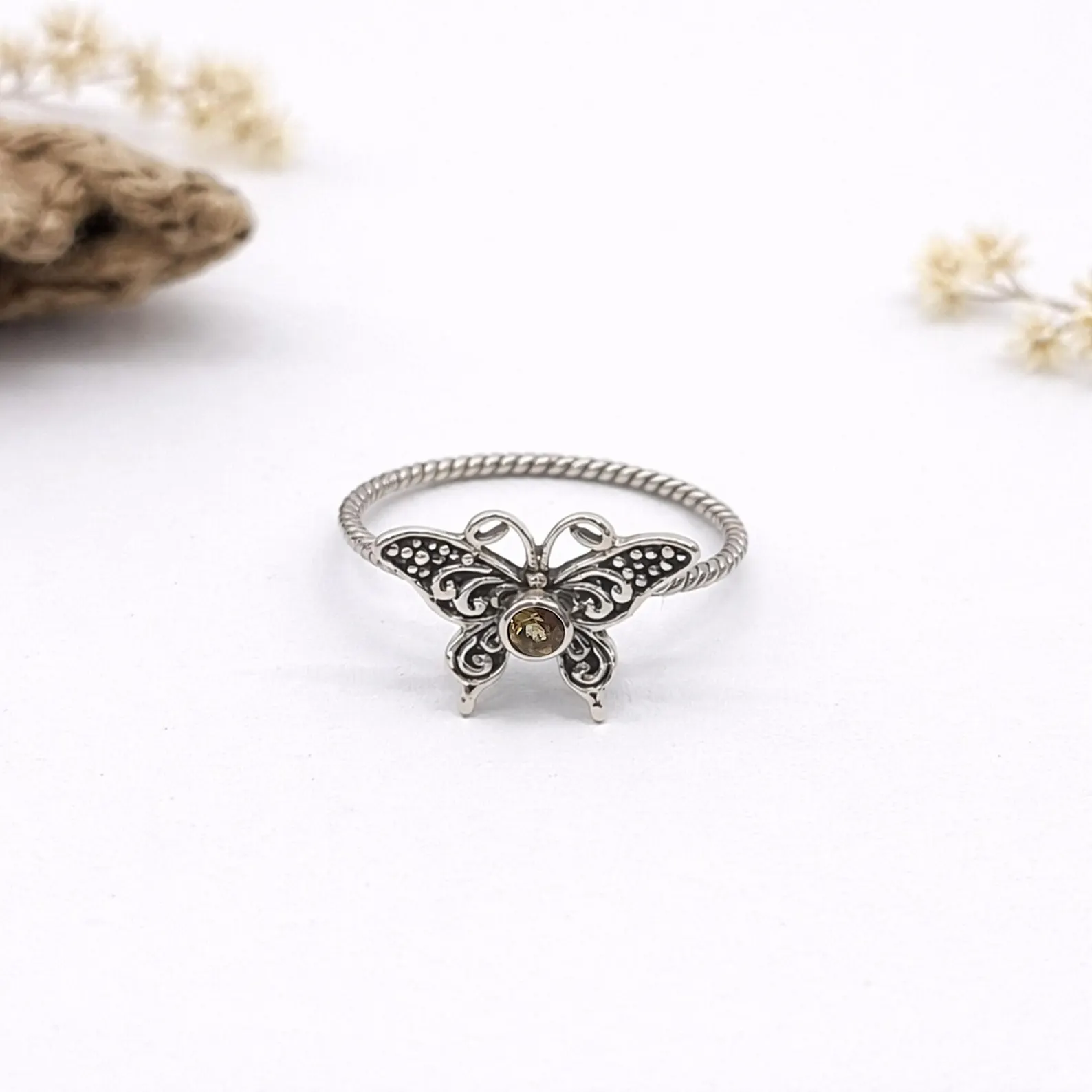 Sterling Silver Butterfly Ring Hero Shot1 Flat lay of minimalist sterling silver butterfly ring design