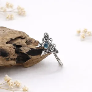 Boho sterling silver butterfly ring styled in natural light