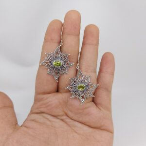 Close-up of boho sun earrings with detailed celestial design