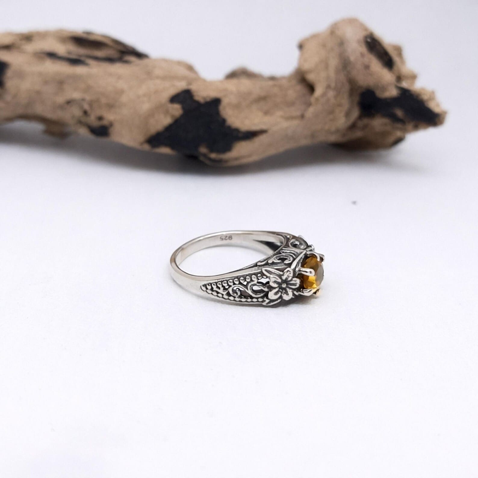 Nature Inspired Flower Ring Worn On Finger Detailed flower pattern sterling silver ring close-up macro view