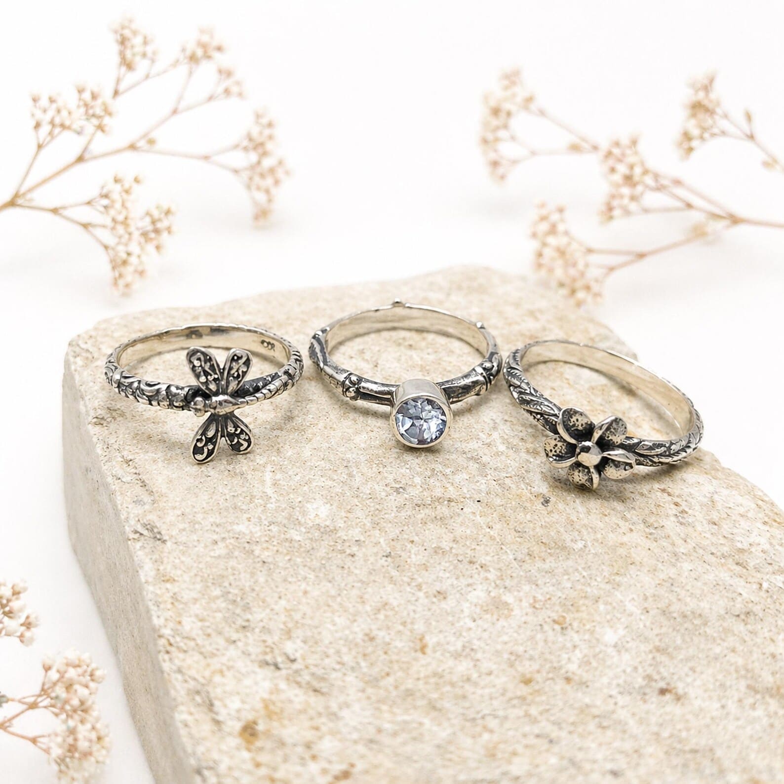 Close Up Frangipani Flower Silver Ring Detail Macro Flat lay of handmade minimalist sterling silver ring set