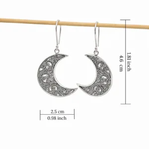 Close-up of boho lunar silver earrings with delicate filigree design