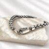 Flat lay of 925 sterling silver geometric chain bracelet