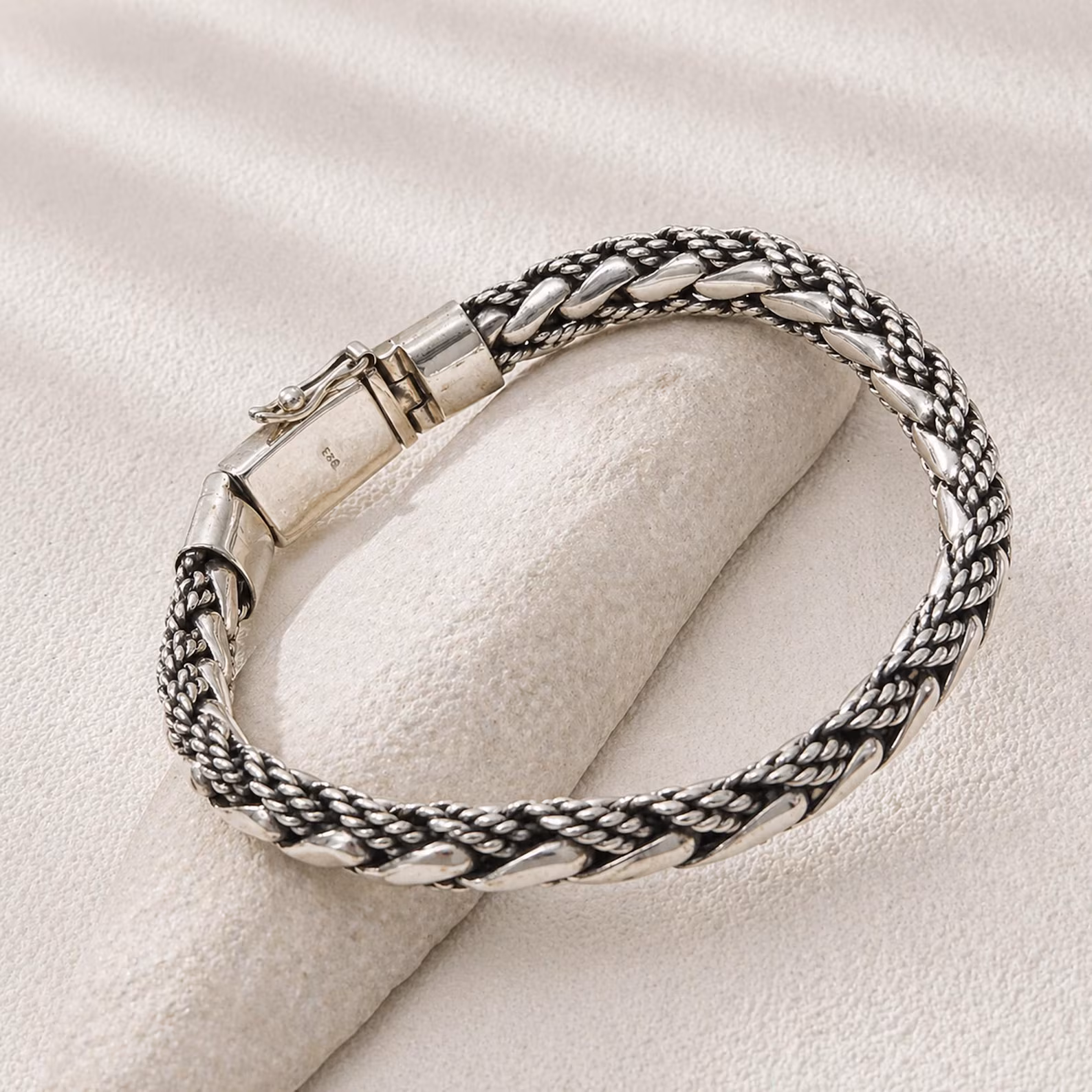 Thick Woven Bracelet Side View Thick handmade silver bracelet with artisan finish