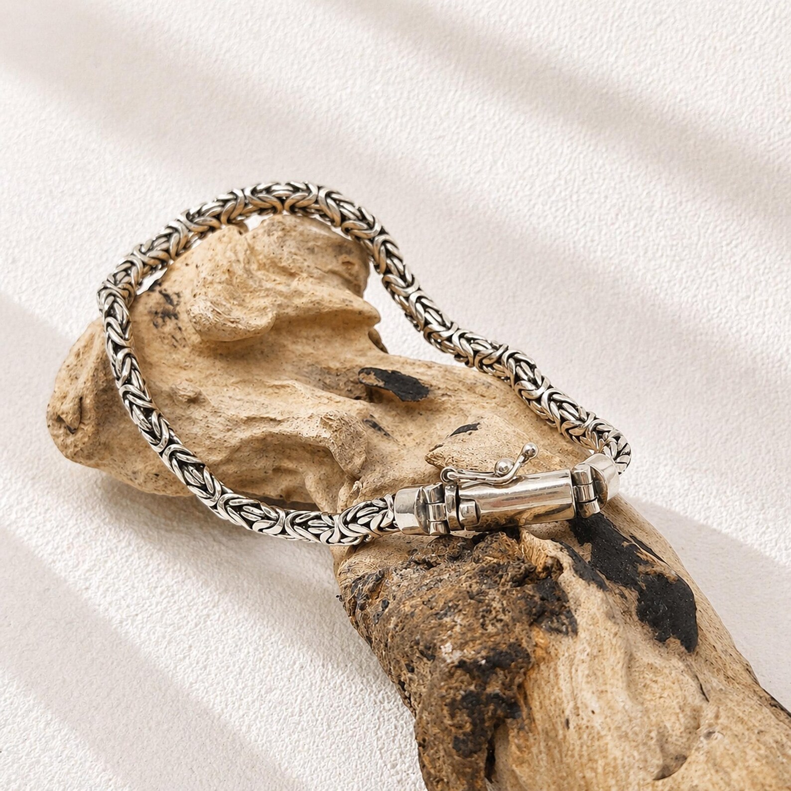 Bold Woven Silver Bracelet on Wrist Close-up of detailed Byzantine chain bracelet texture