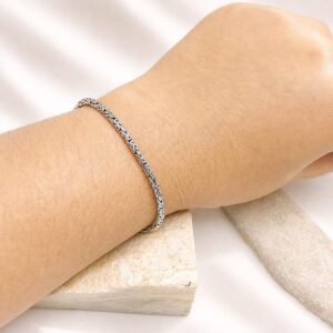 Minimalist thin silver bracelet worn on wrist