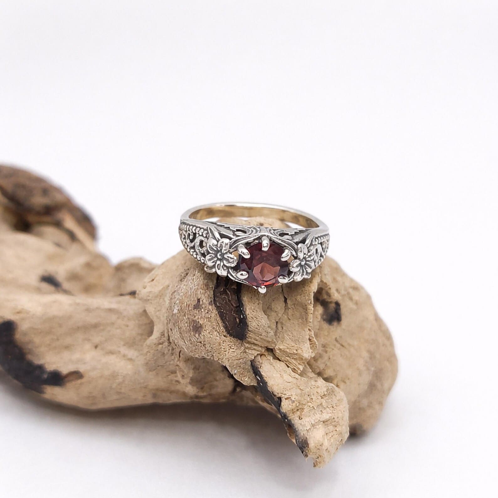 Handmade Bali Flower Ring On Hand Lifestyle Shot Flat lay of handmade sterling silver flower ring premium styling