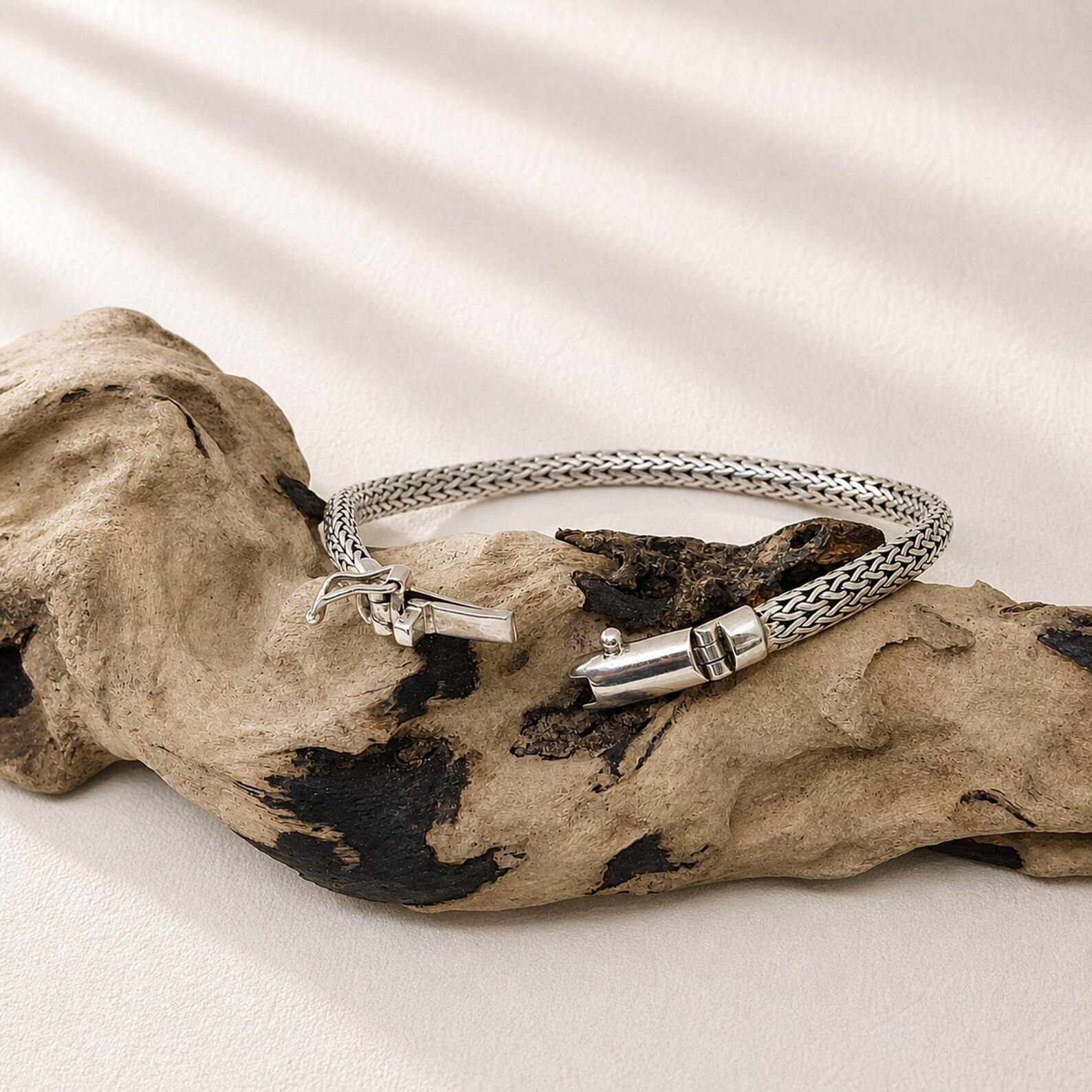 Herringbone Chain Bracelet Studio Shot Elegant silver snake chain bracelet with fluid design