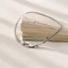Close-up of fine woven silver bracelet detail