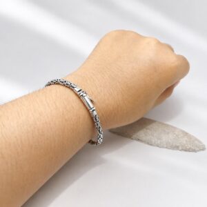 Bold woven silver bracelet worn on wrist