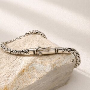 Flat lay of sterling silver Byzantine chain bracelet