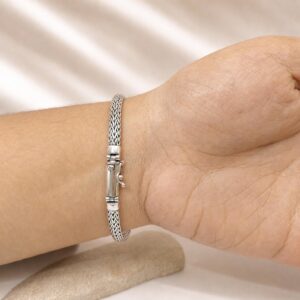 Modern minimalist silver bracelet styled for layering