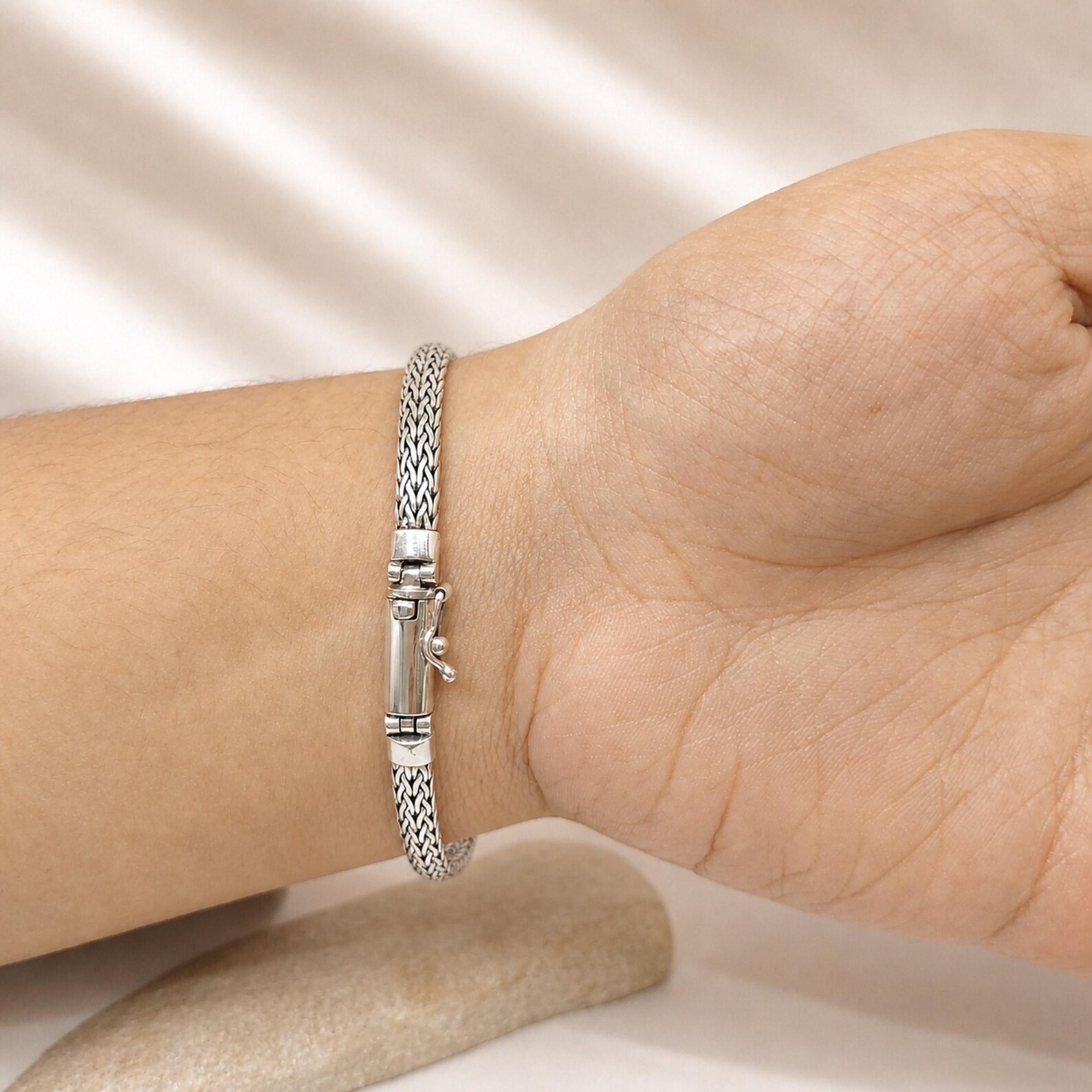Minimalist Snake Chain Bracelet Flat Lay Modern minimalist silver bracelet styled for layering