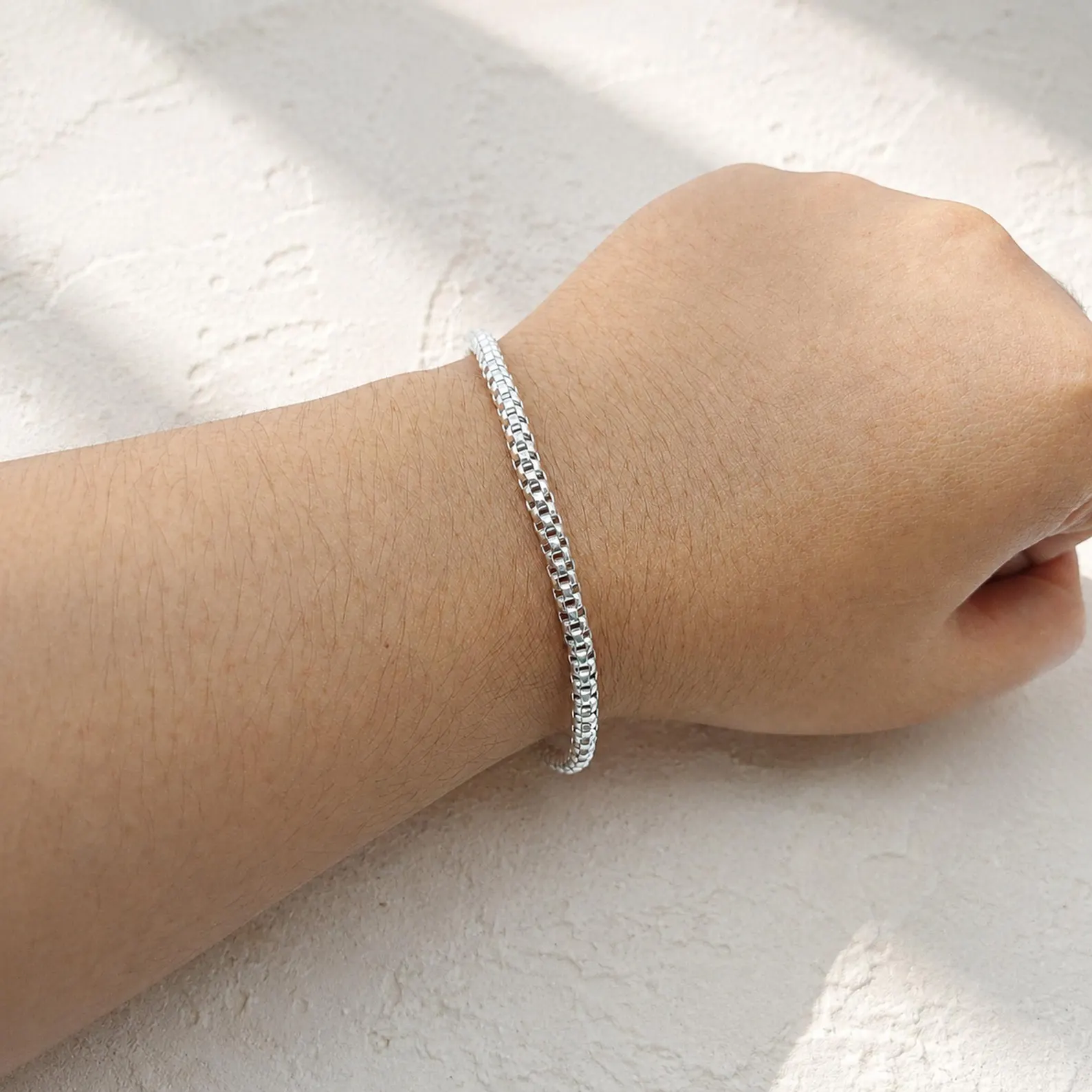 Minimalist Silver Bracelet Close-up Detail Elegant handmade silver bracelet with smooth box chain links