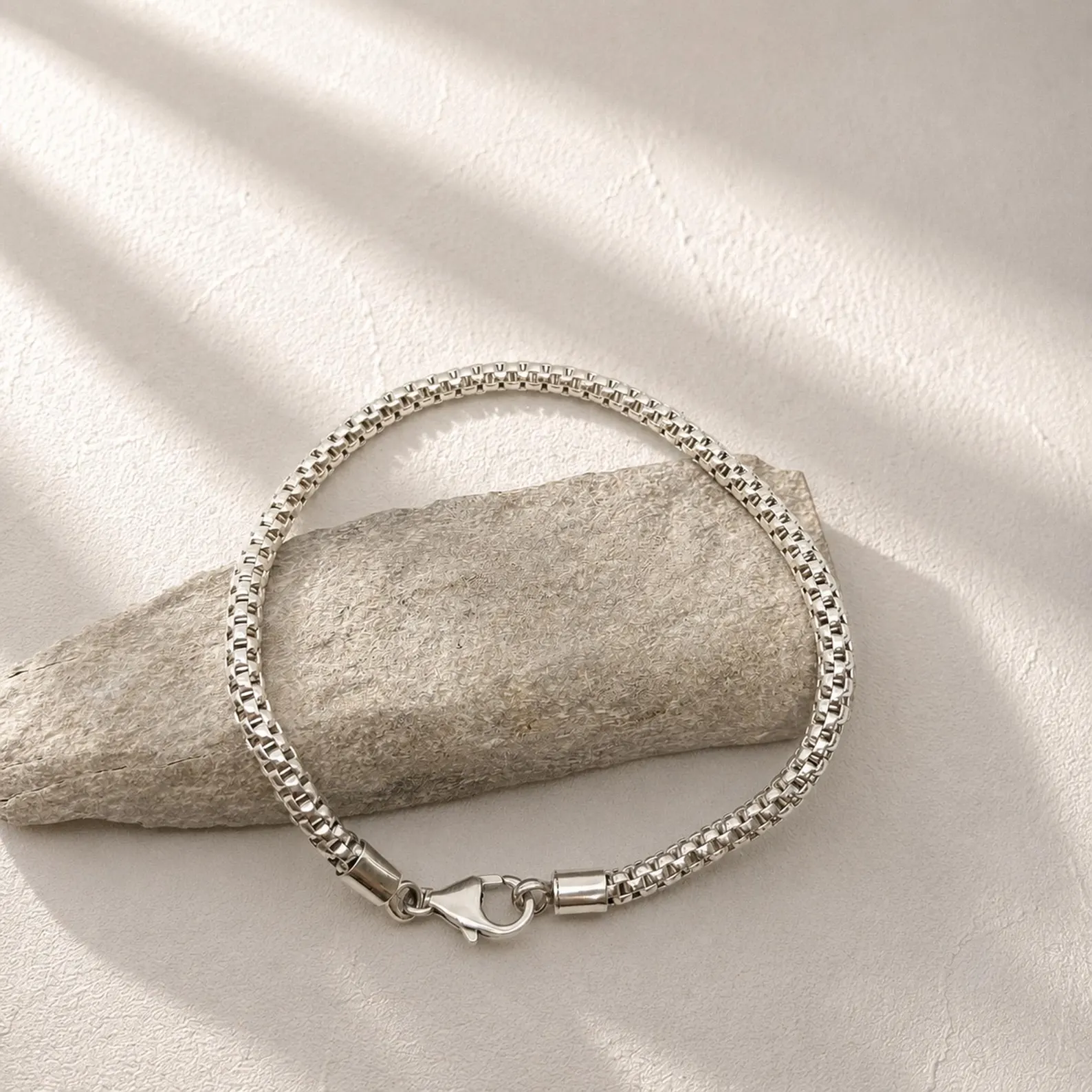 Elegant Minimal Bracelet Side View Close-up of elegant silver box chain bracelet detail