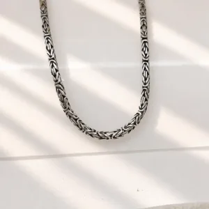 Unisex sterling silver chain styled in natural light aesthetic