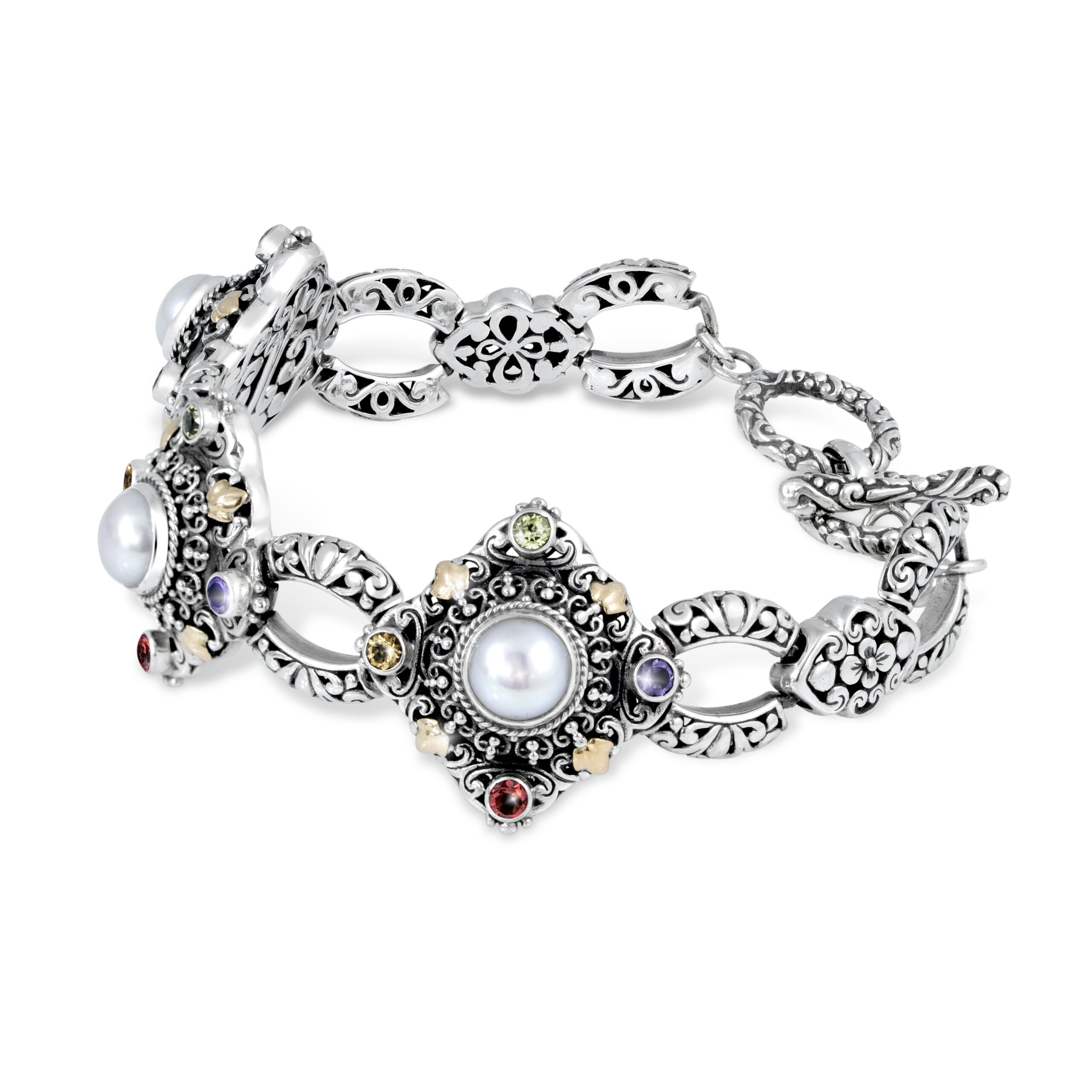 Ornate Silver Bracelet with Pearls and Multicolor Gemstones Balinese silver bracelet featuring pearls, amethyst, garnet, citrine, peridot, and gold-plated accents