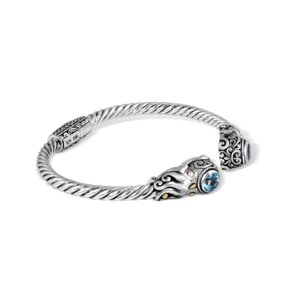 Close-up of an Indonesian sterling silver octopus cuff bracelet with 18K gold-plated accents and blue topaz