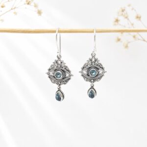 Ornate Balinese silver gemstone earrings close up